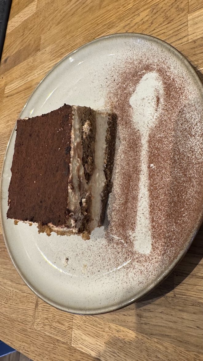 A slice of chocolate cake stencilled with cocoa