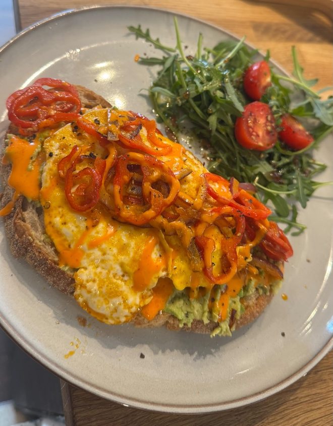 Loaded toast with egg, cheese and peppers on a plate